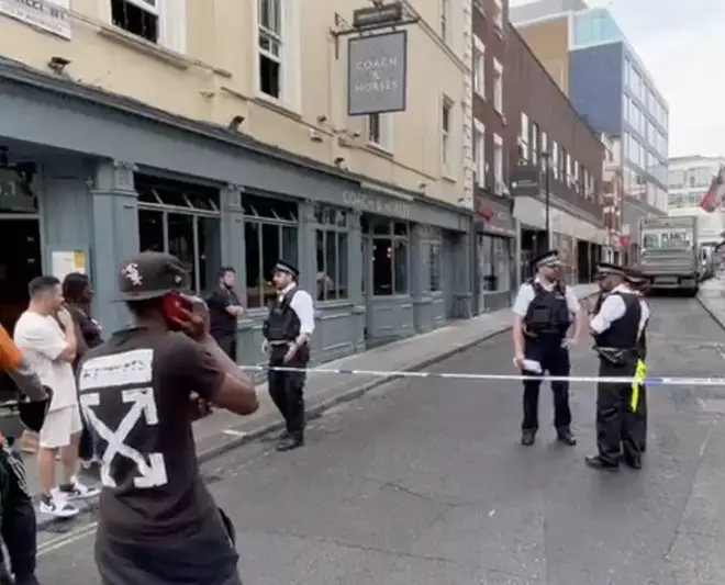 Police at Poland Street, one of the scenes of the recent killings in London's crime wave