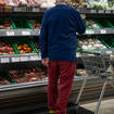 A shopper looks at fresh produce in a supermarket