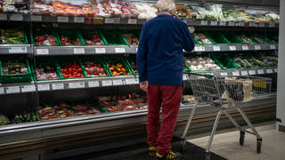 A shopper looks at fresh produce in a supermarket