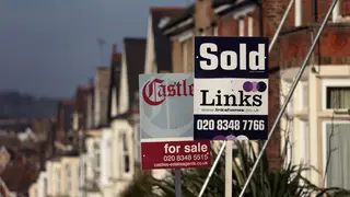 Estate agents' boards outside a row of houses