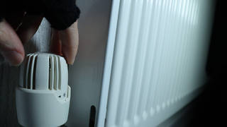 A resident turning their radiator down