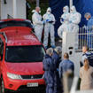 Forensic investigators at the scene in Auckland where the children's bodies were found