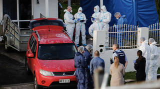 Forensic investigators at the scene in Auckland where the children's bodies were found