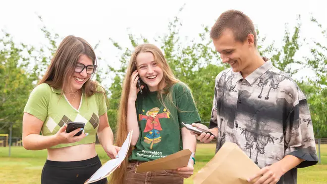 Star and Storm Powell with friend Joey Mayley get on the phone to their parents as they receive their results at The Bewdley School, Worcestershire