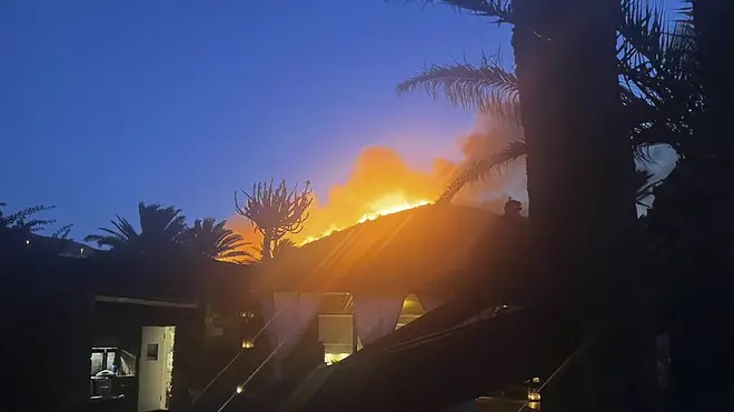 Flames burn beyond Giorgio Armani’s villa on the Sicilian island of Pantelleria