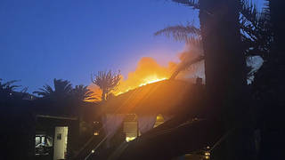 Flames burn beyond Giorgio Armani’s villa on the Sicilian island of Pantelleria