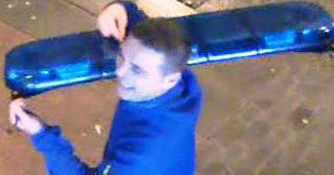 CCTV has been released of a man carrying police lights on his shoulder