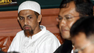 Umar Patek, an Indonesian militant charged in the 2002 Bali terrorist attacks, left, sits with his lawyer during his trial in Jakarta, Indonesia