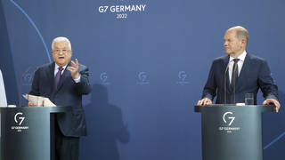 Palestinian President Mahmoud Abbas, left, speaks during a news conference after a meeting with German Chancellor Olaf Scholz, right, at the Chancellery in Berlin