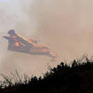 A firefighting airplane over a wildfire near Alcublas in eastern Spain