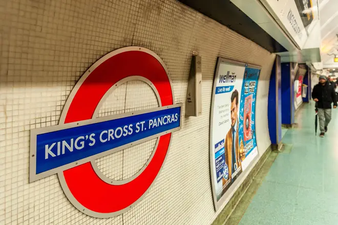 A man has been arrested on suspicion of attempted murder after he allegedly tried to pull a woman onto train tracks at King's Cross Underground Station. 