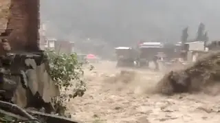 The footage depicts a torrent of water crashing through the Swat region