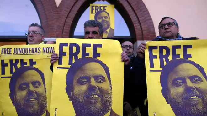 Demonstrators hold banners with an image of former Catalan vice president Oriol Junqueras on them