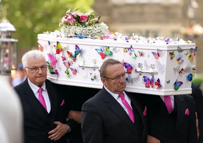 Lilia's coffin being carried into the church
