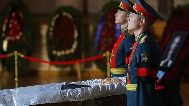 The open casket was flanked by honorary guards