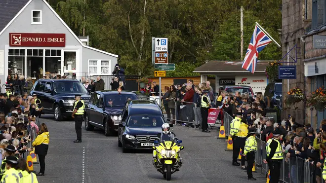 Well wishers gather in Ballater, Aberdeenshire, to watch as the Queen's coffin travels from Balmoral to Edinburgh