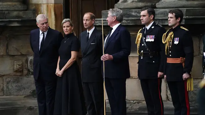 Prince Andrew, Prince Edward and his wife Sophie, Countess of Wessex, watch as the Queen's coffin arrives in Edinburgh