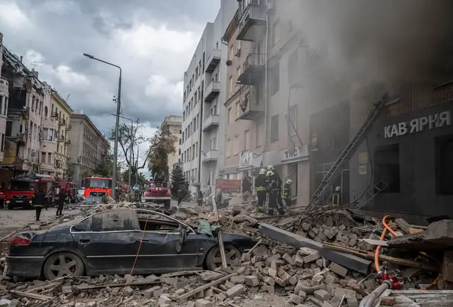 Firefighters work at the site of a residential building hit by a Russian military strike, amid Russia's attack on Ukraine, in Kharkiv