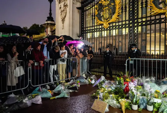 Those paying their respects gather outside Buckingham Palace the day after the Queen died