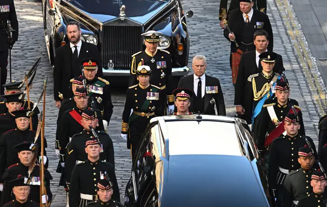 Charles III flanked by Princess Anne; Princess Royal, Prince Andrew; Duke of York, and Prince Edward; Earl of Wessex, as they trail behind Queen Elizabeth II's coffin at a procession through Edinburgh