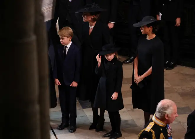 Prince George and Princess Charlotte stand with the Princess of Wales and Duchess of Sussex during the service