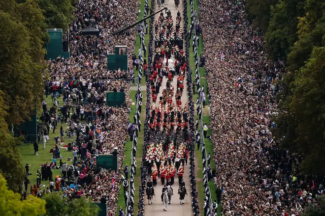 The Queen's coffin was showered with flowers as it left London before its journey down the Long Walk