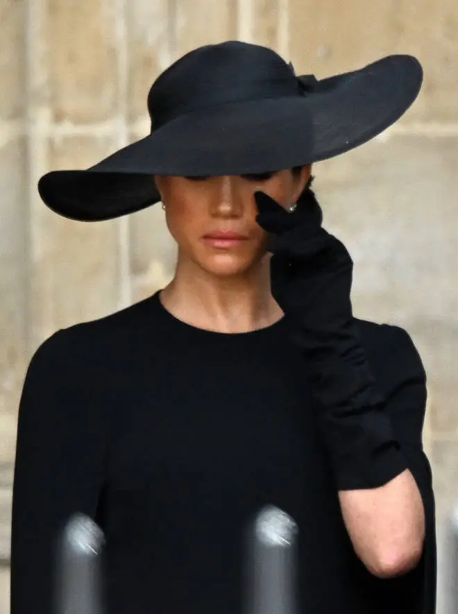 The Duchess of Sussex wiped away a tear as she said goodbye to the Queen