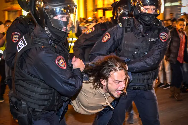 Russians were hauled away by police