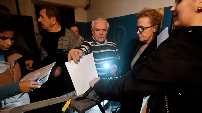 Voters cast their ballot in Donetsk