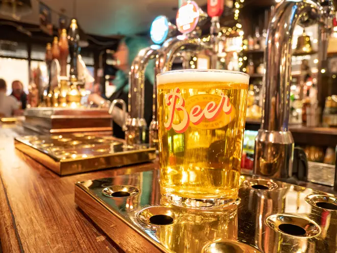 Pint of lager on pub bar, London, UK