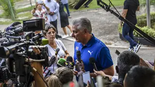 Cuba’s President Miguel Diaz Canel speaks to the press after casting his vote at a polling station