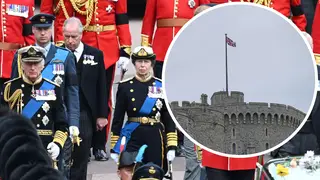 The royals walking behind the funeral procession with flags back at full-mast over Windsor Castle