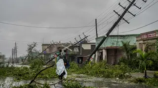 Fallen utility poles and branches line a street after Hurricane Ian hit Pinar del Rio, Cuba