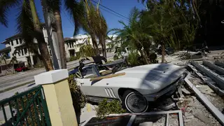 A classic sports car sits where it landed after Hurricane Ian
