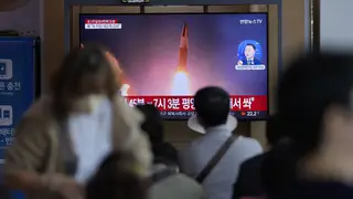 A TV screen in a rail station in Seoul, South Korea, shows a news programme reporting the missile launch