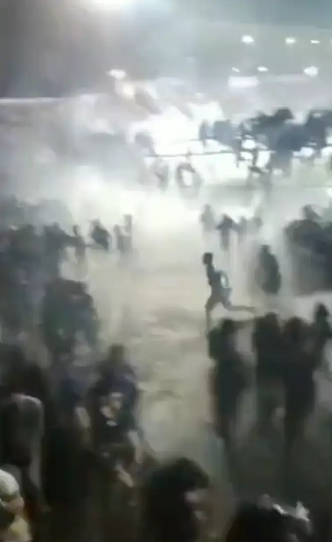 Police opened fire with tear gas to try and clear a pitch invasion