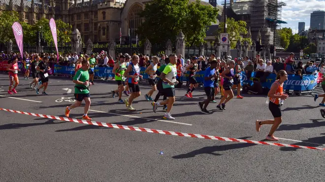 London Marathon passes through Parliament Square past Big Ben and Houses of Parliament.