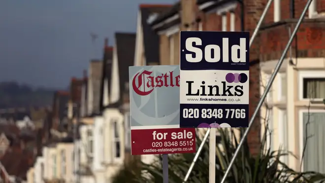 Estate agents' boards outside a row of houses