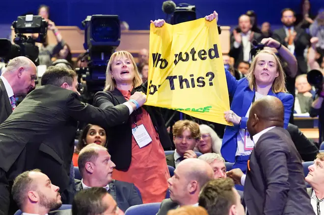 Security guards pulled a banner out of the protesters' hands