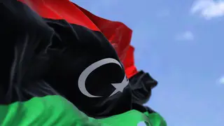 Detail of the national flag of Libya waving in the wind on a clear day. Patriotism. North african country. Selective focus.