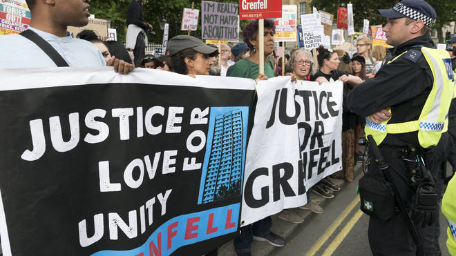 Protesters from Justice for Grenfell with a banner at march in Downing Street Photo: PA