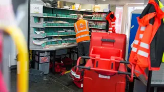 A man working in a Royal Mail sorting office