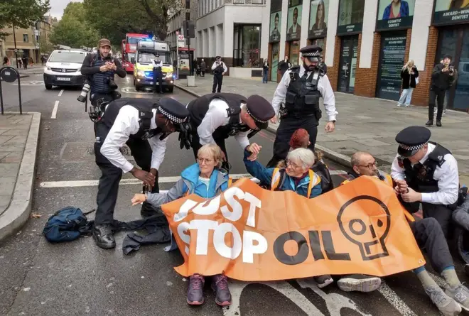 Police move on a group of protesters this morning from the busy London junction
