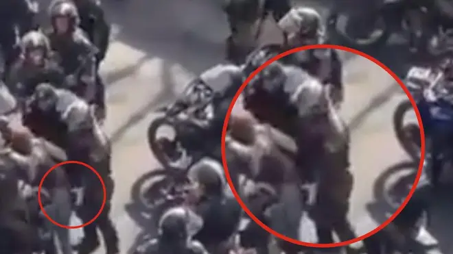 An Iranian riot police officer has been filmed sexually assaulting a protester