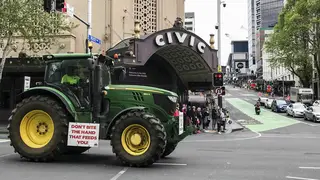 A tractor drives down Queen street in central Auckland during a protest on climate change proposals to make New Zealand farmers pay for greenhouse gas emissions