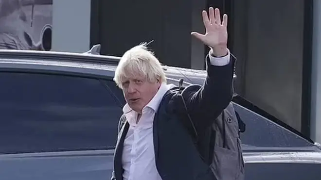 Boris Johnson is pictured arriving back at Gatwick Airport from the Caribbean on Friday.