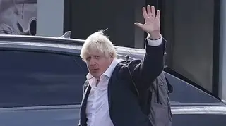 Boris Johnson is pictured arriving back at Gatwick Airport from the Caribbean on Friday.
