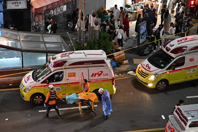 The body of a victim of cardiac arrest is transported in the popular nightlife district of Itaewon in Seoul on October 30, 2022