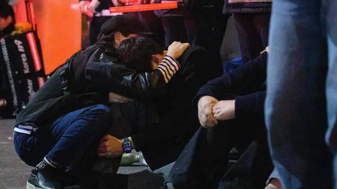Survivors are comforted at the scene of the accident on Saturday night
