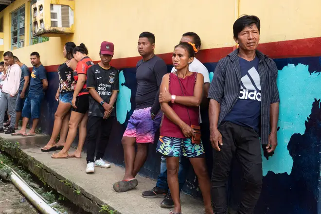 Brazilian indigenous Tikuna people queue to vote